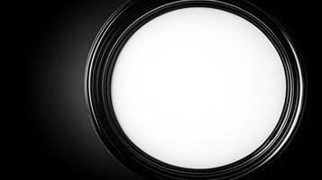 Circular light fixture casting a soft glow in a darkened room photo