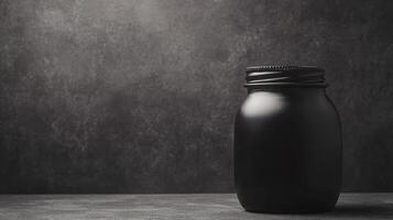 Sleek black jar showcased against a textured background photo