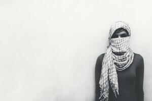 Masked individual standing against a plain white background photo