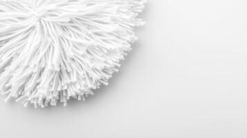 Soft white mop head resting on a clean surface for cleaning tasks photo
