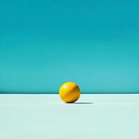 Vibrant orange sphere against a tranquil turquoise backdrop photo
