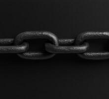 Strong black chain links on a dark background creating a bold effect photo