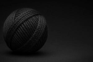 Creative black yarn ball on a dark background captures attention photo