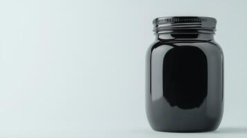 Glossy black jar stands elegantly against a pale background photo