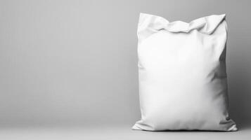 Blank white sack resting on a simple gray background photo