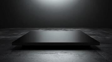 Minimalistic black platform in a dimly lit space photo
