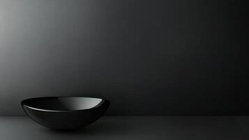Elegant black bowl on a minimalist dark surface photo