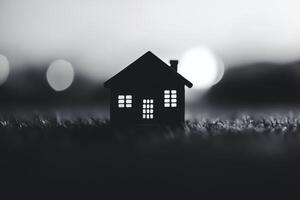 House silhouette illuminated at night on grassy surface photo