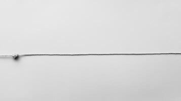 White rope tied in a knot against a plain background photo