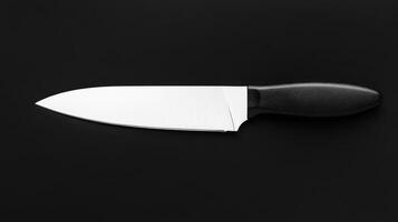 Chef's knife on a black surface for culinary preparation photo