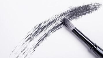 Brush creating a stroke on white paper surface photo