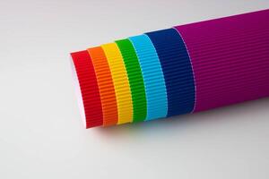 A roll of multicolored sheets of corrugated paper photo