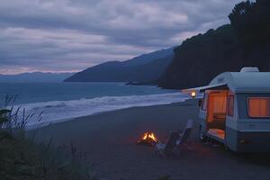 A peaceful camping scene on the beach at sunset, featuring a camper caravan parked by the shore, with the sun setting over the horizon, creating a serene and relaxing atmosphere. photo