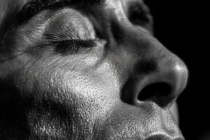 A closeup portrait of a mans face, decorated with striking black and white paint, creating a bold and artistic visual effect. photo