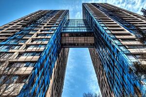 A low angle view of modern skyscrapers in London, highlighting the impressive architecture and towering buildings of the city's financial district. photo