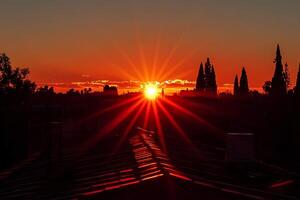 A breathtaking sunset casting warm golden light over the rooftops of an old town, with the rays of the setting sun creating a serene and magical atmosphere photo