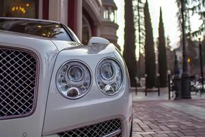 A pristine white Bentley luxury car with the door slightly open, showcasing elegance and sophistication photo