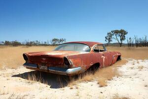 An abandoned car in the rugged Australian outback, surrounded by the vast, arid landscape of Victoria, evoking a sense of isolation and decay photo
