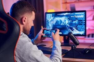 A man is playing a game on his phone photo