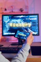 A man is playing a game on his phone photo