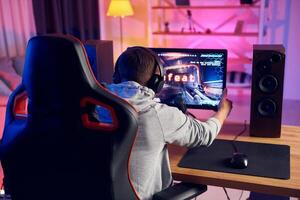 A man is playing a game on a computer photo