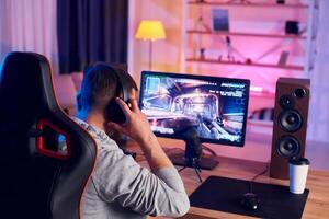 A man is playing games on a computer photo