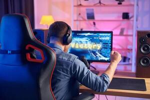 A man is playing games on a computer photo