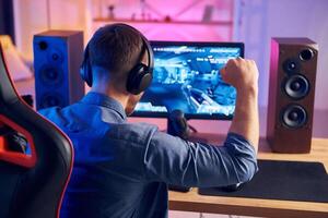 A man is playing games on a computer photo