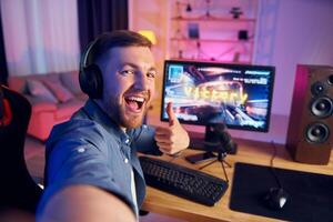 A man is playing a game on his computer photo