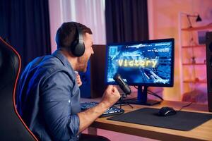 A man is playing games on a computer photo