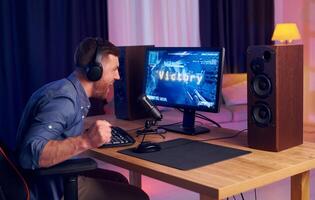 A man is playing games on a computer photo
