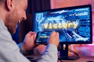 A man is playing a game on his computer photo