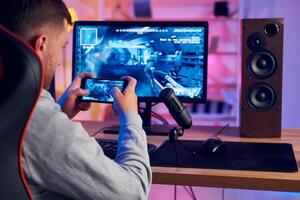 A man is playing a game on his computer photo
