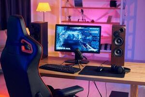 A gaming chair and a computer monitor on a desk photo