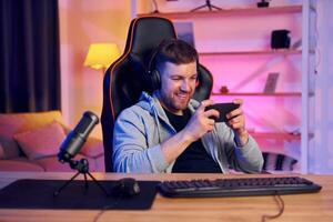 A man in headphones is playing a game photo