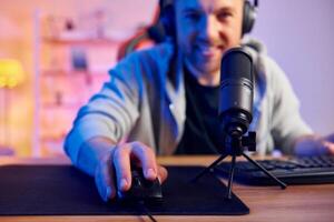 A man is using a microphone and a computer mouse photo