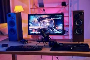 A computer monitor, keyboard and mouse on a desk photo