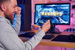A man is playing a game on his computer photo