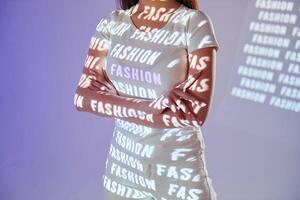 A woman in a white dress with the words fashion on it photo