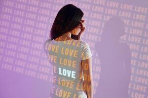 A woman wearing a t - shirt with the word love on it photo
