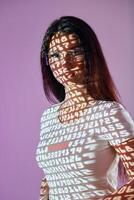 A woman wearing glasses and a white t - shirt with the words data projected on it photo