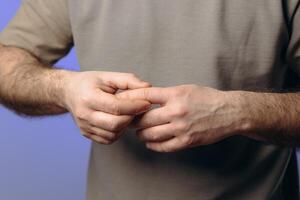 man suffers from chronic arthritis. pain in the joints of the fingers. inflammation of the joints, which can be caused by osteoarthritis wear of cartilage or rheumatoid arthritis. hands close-up photo