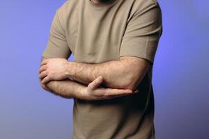 A man experiences problems in the elbow after intense physical exercise, long training or professional activities. performing a warm-up and recovery after physical exercise. photo