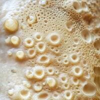 A close up of a white cake with bubbles photo