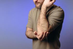 A man experiences problems in the elbow after intense physical exercise, long training or professional activities. performing a warm-up and recovery after physical exercise. photo