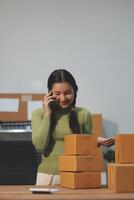A woman talking on the phone while standing in front of boxes photo