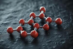 A red molecule on a black surface photo