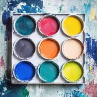 A paint palette with different colors on a grungy background photo