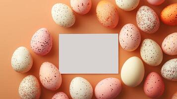 Easter eggs arranged around a blank card on an orange background, space for text photo