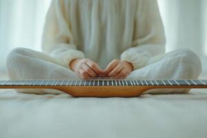 Musician practices guitar in serene indoor setting during morning sunlight photo